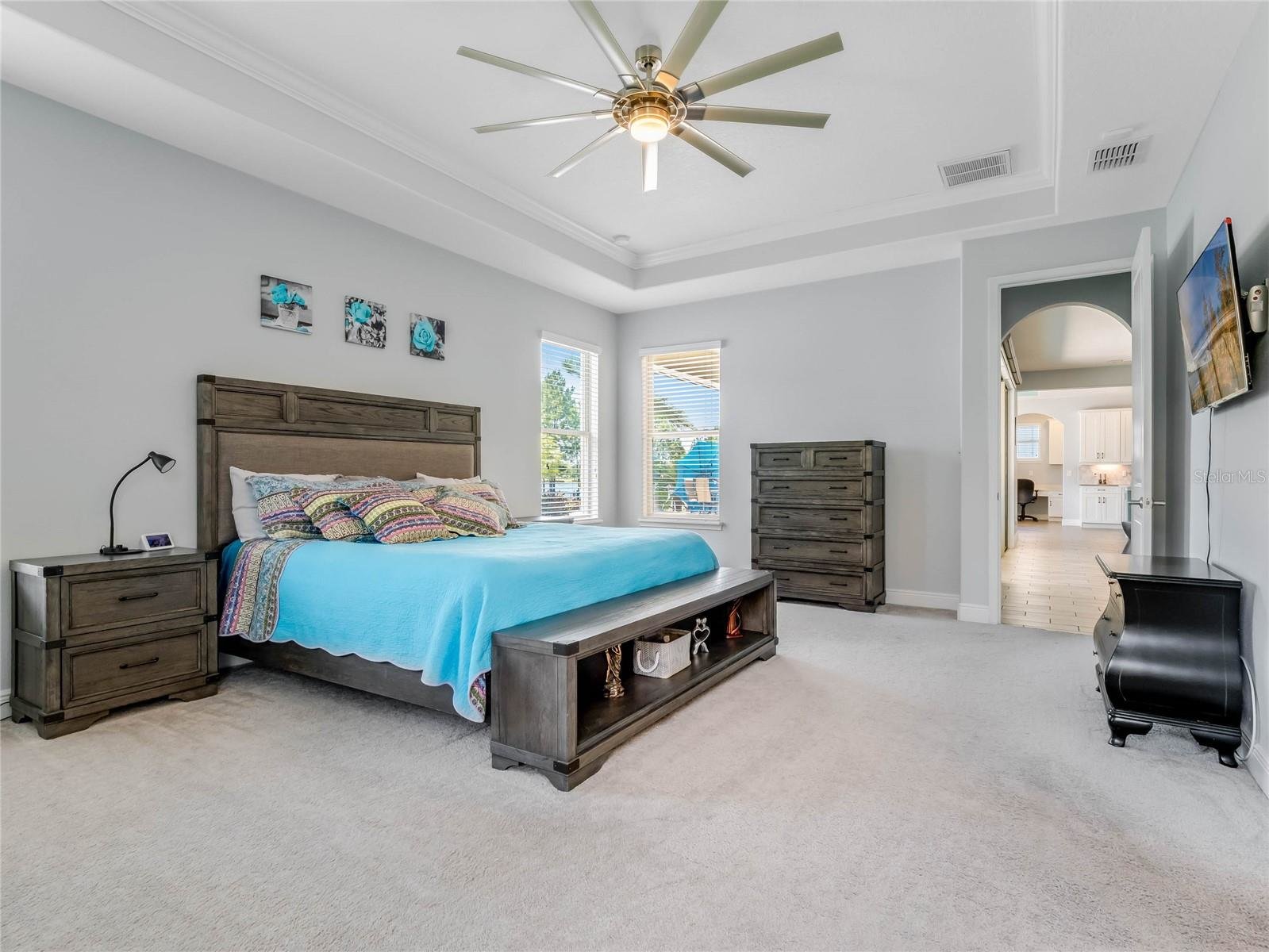 large master suite with hallway to bathroom and closets